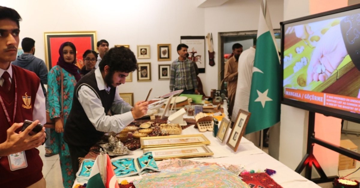 Visitors exploring cultural displays and creative works at an Art Exhibition Lahore, featuring traditional crafts, artwork, and interactive presentations.
