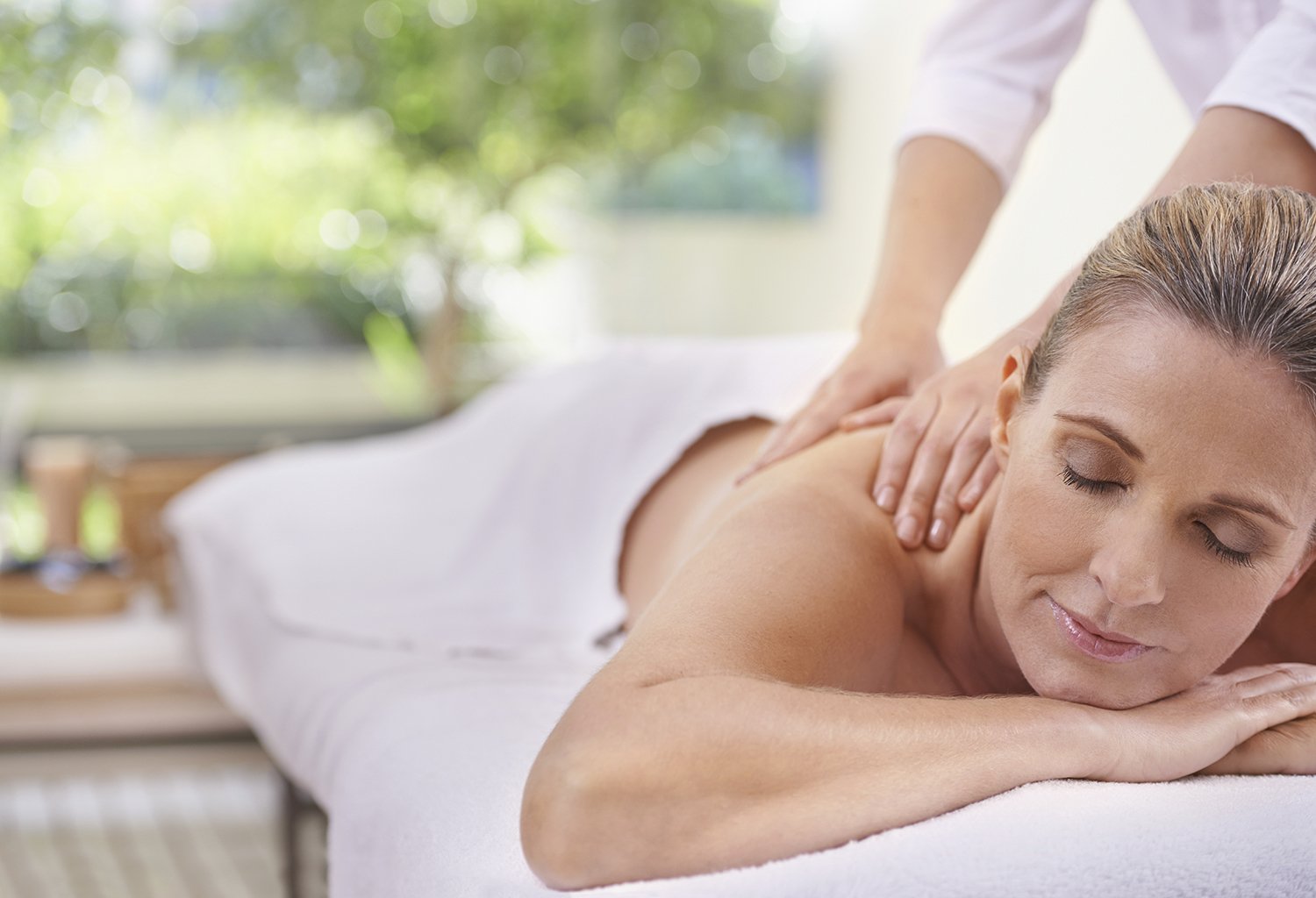 Woman receiving a relaxing shoulder and back treatment at a spa, demonstrating the benefits of Lymphatic Drainage Massage Oakton VA for wellness and relaxation.